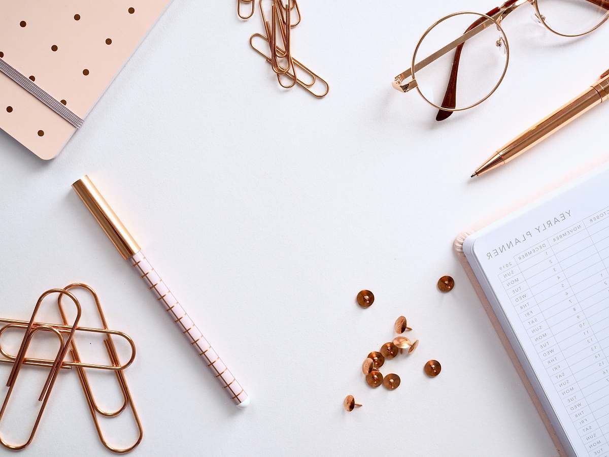 coffs harbour book beside thumbtacks, pens, paperclips, and eyeglasses australia
